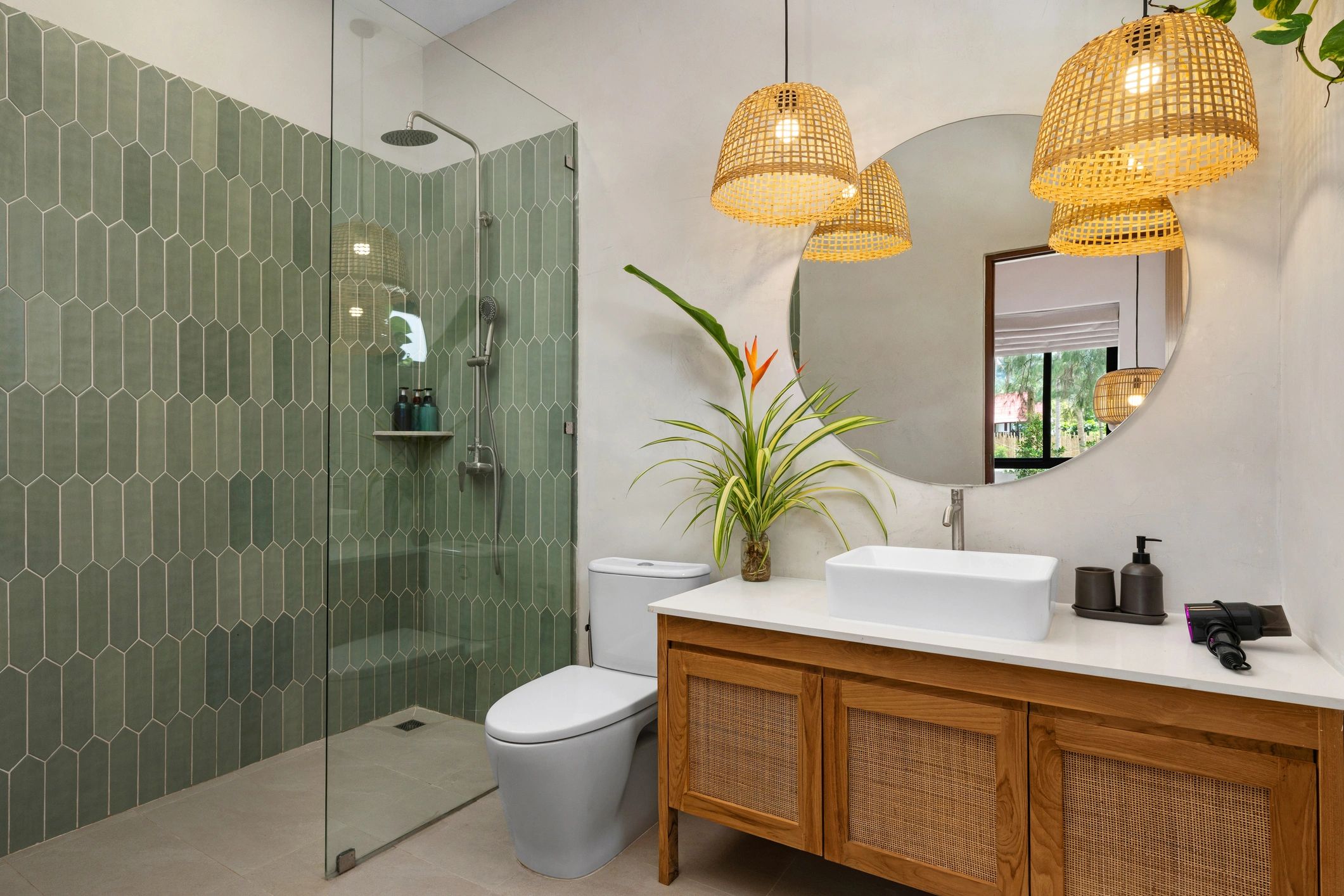 Modern bathroom with glass shower enclosure and round mirror